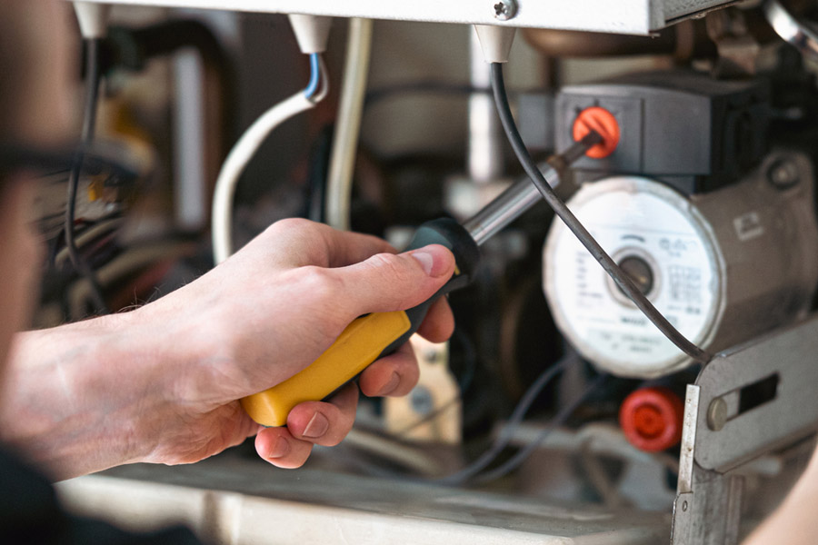 Technician performing prime-start service in Commack, NY